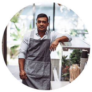 shop owner standing next to counter 