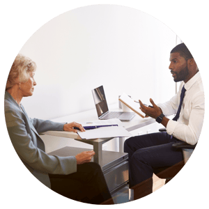 tax professional talking with client at a table while sitting