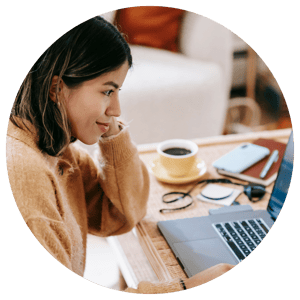 woman working remotely on laptop with coffee