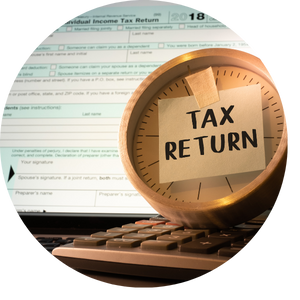 tax return note on clock with tax return form 