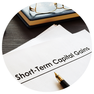 short term capital gains printed on paper next to pen