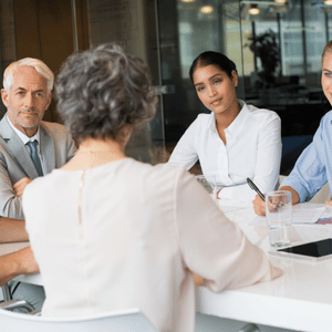 group of professional people sitting at table 