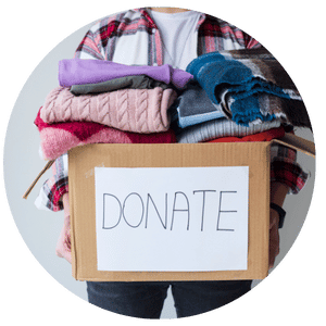 person carrying a donation box with clothes inside