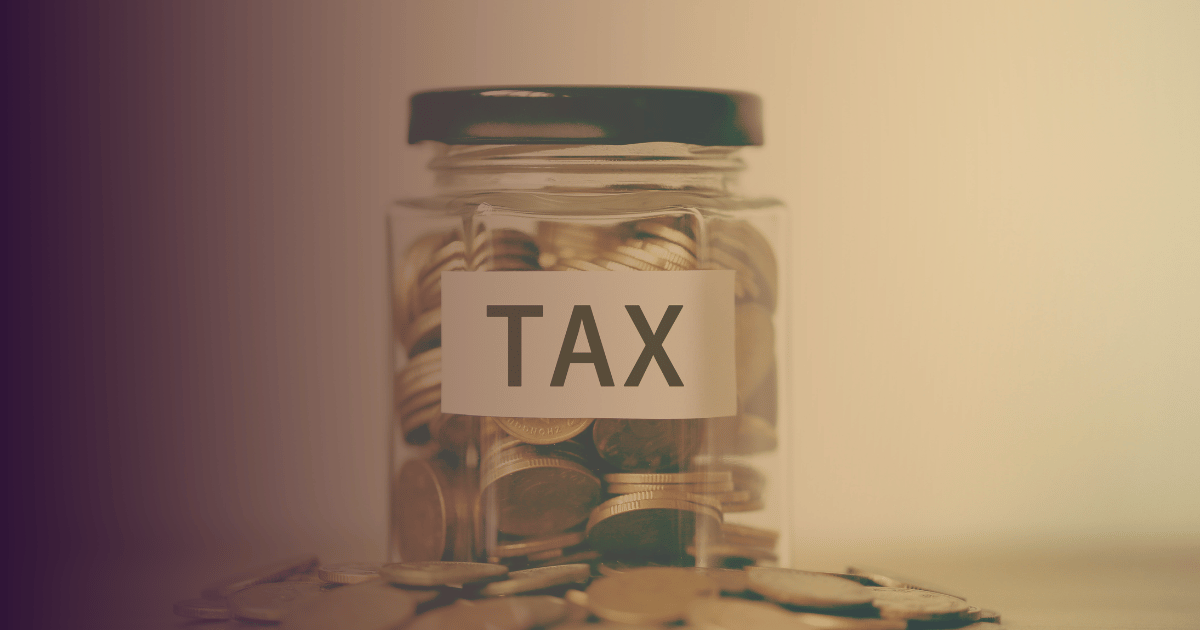 coins in a jar labeled tax surrounded by more coins